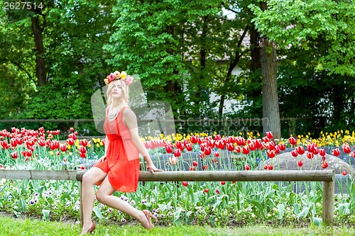 Image of beautiful woman portrait outdoor with colorful flowers