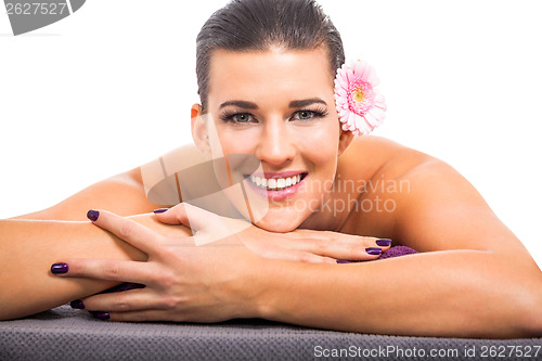 Image of young attractive woman hot stone massage wellness