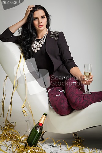 Image of Seductive brunette holding a glass of champagne