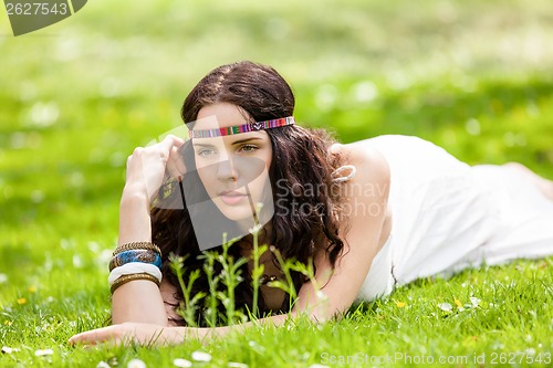 Image of Pretty young woman in a headband daydreaming