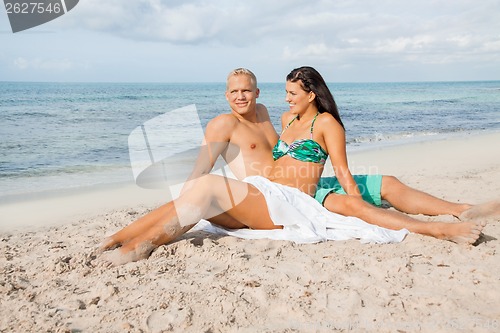 Image of Happy young couple sunbathing