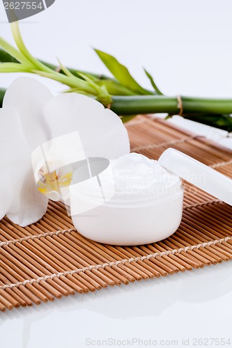 Image of cosmetic face cream on wooden background 