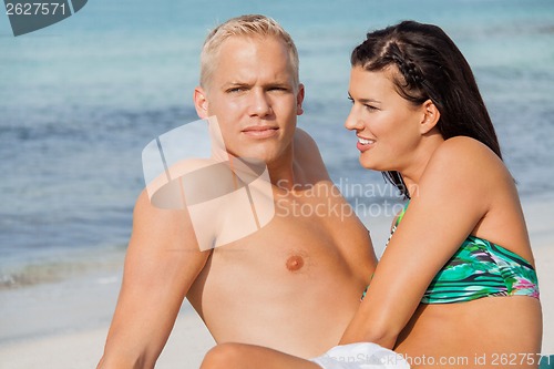 Image of Happy young couple sunbathing