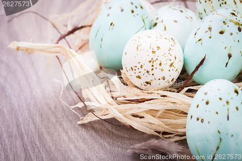 Image of Three natural blue Easter eggs in a basket