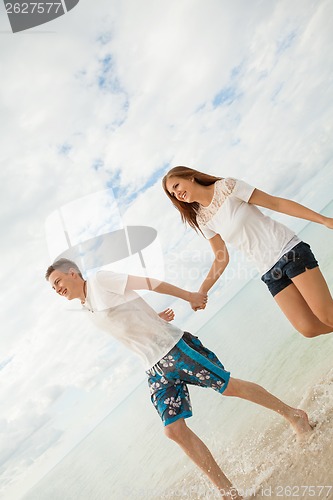 Image of happy young couple on the beach in summer holiday love