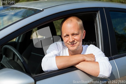 Image of Excited driver holding the keys of his new car