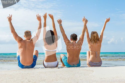 Image of young happy friends havin fun on the beach