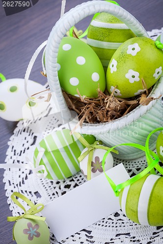 Image of Colourful green Easter eggs in straw