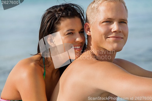 Image of Happy young couple sunbathing