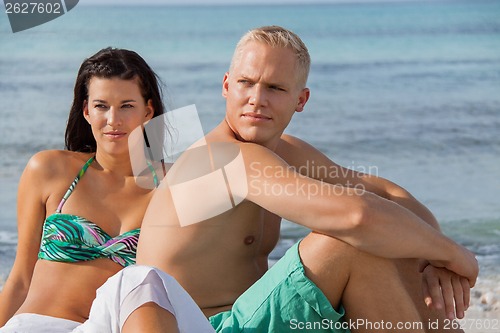 Image of Happy young couple sunbathing