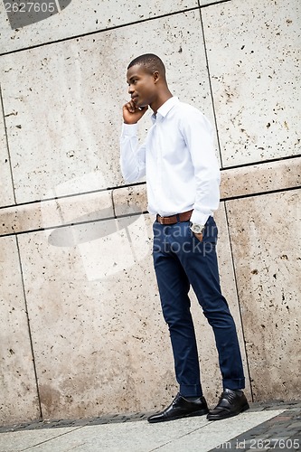 Image of young successful african business man outdoor in summer