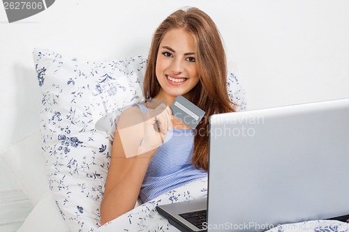 Image of Beautiful woman doing online shopping