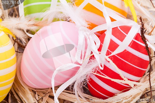 Image of colorful easter egg decoration on wooden background