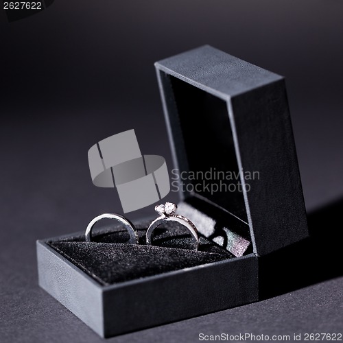 Image of Engagement ring with a bunch of red roses