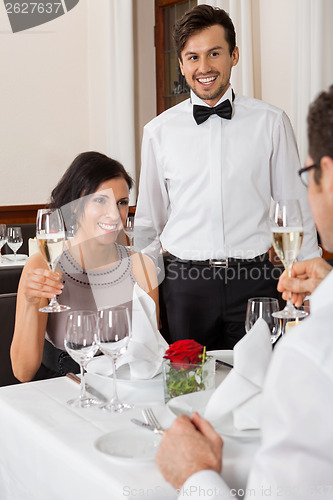 Image of young smiling couple at the restaurant 