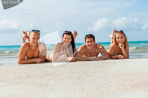 Image of young happy friends havin fun on the beach