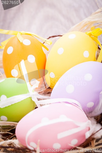 Image of colorful easter egg decoration on wooden background