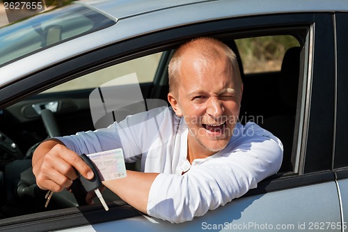 Image of Excited driver holding the keys of his new car