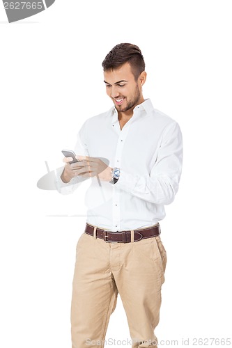 Image of Handsome man reading a message on his mobile