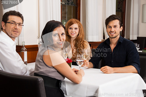 Image of smiling happy people friends in restaurant