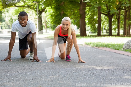 Image of young couple runner jogger in park outdoor summer