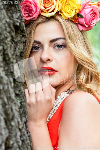 Image of beautiful woman portrait outdoor with colorful flowers