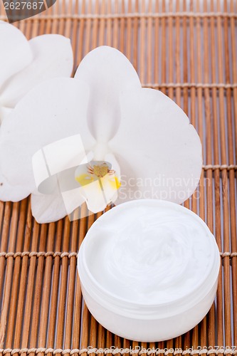 Image of cosmetic face cream on wooden background 