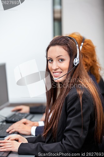 Image of friendly callcenter agent operator with headset telephone 