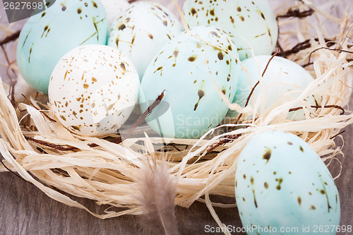 Image of Three natural blue Easter eggs in a basket