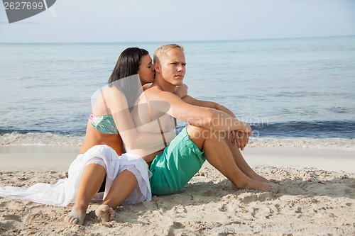 Image of Happy young couple sunbathing