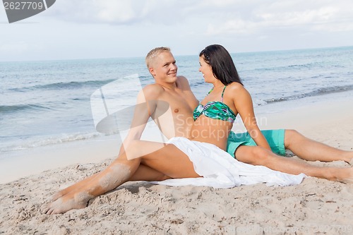 Image of Happy young couple sunbathing