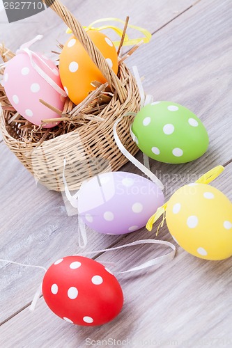 Image of colorful easter egg decoration on wooden background