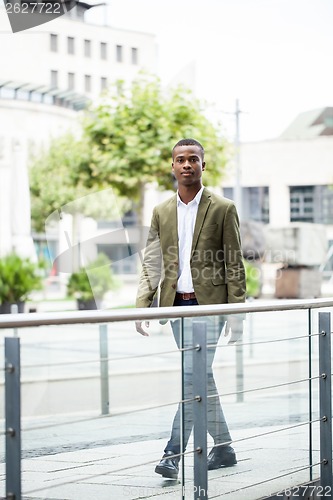Image of young successful african business man outdoor in summer