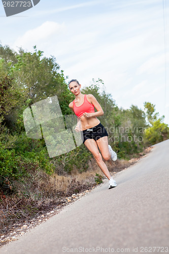 Image of young athletic woman runner jogger outdoor