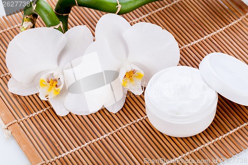 Image of cosmetic face cream on wooden background 