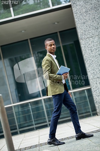 Image of young successful african business man outdoor in summer