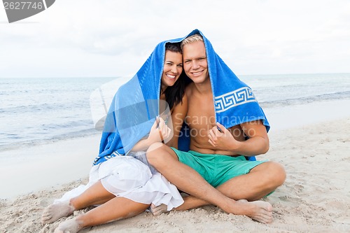 Image of Cheerful couple with a towel covering their heads