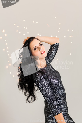 Image of Beautiful dreamy woman with glitter dress dancing