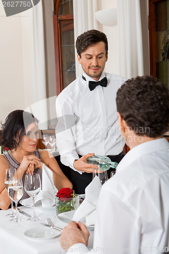 Image of young smiling couple at the restaurant 