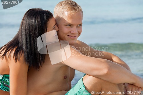 Image of Happy young couple sunbathing