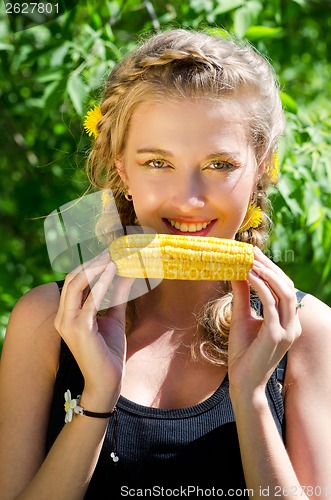 Image of woman eating corn-cob