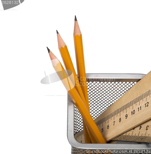 Image of Some yellow pencils and wooden ruler in support