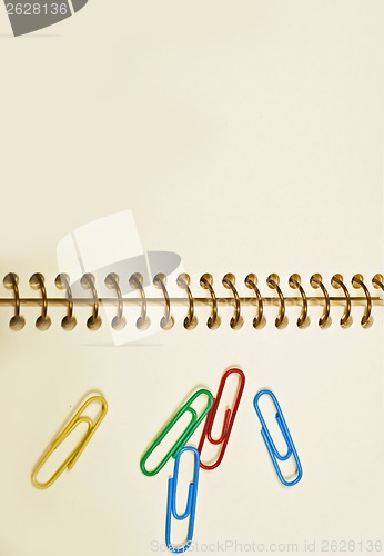 Image of paper clips office in an empty notebook