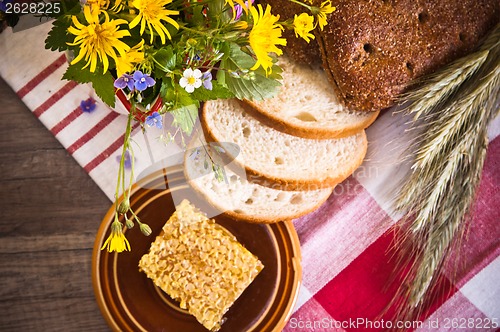 Image of Still life with honeycombs, flowers and pot