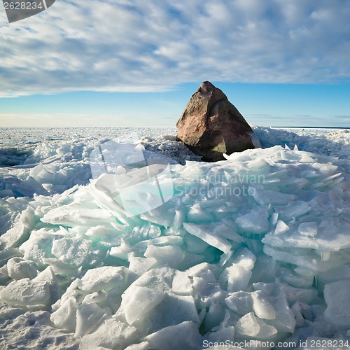 Image of Big stone in the ice on the Baltic Sea coas