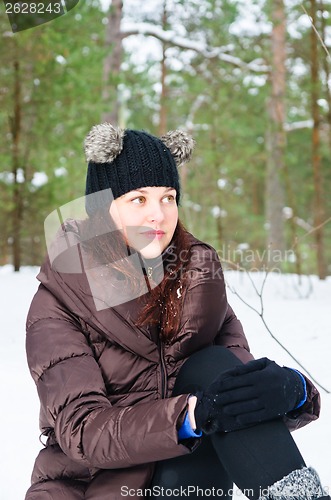 Image of Portrait of the charming young woman in winter outdoors