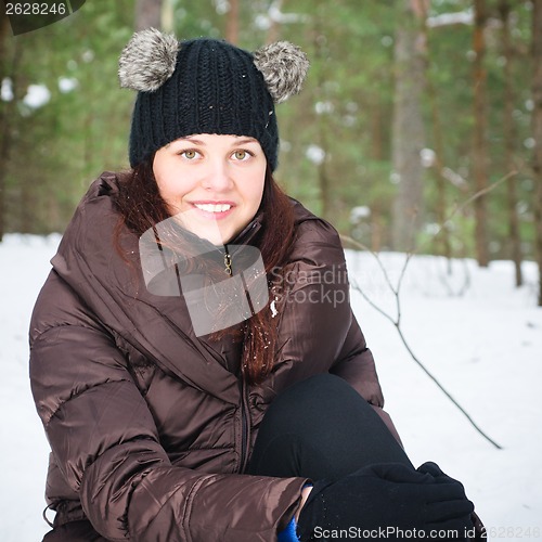 Image of Portrait of the charming young woman in winter outdoors