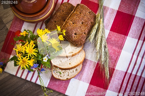 Image of Still life with bread, flowers and pot