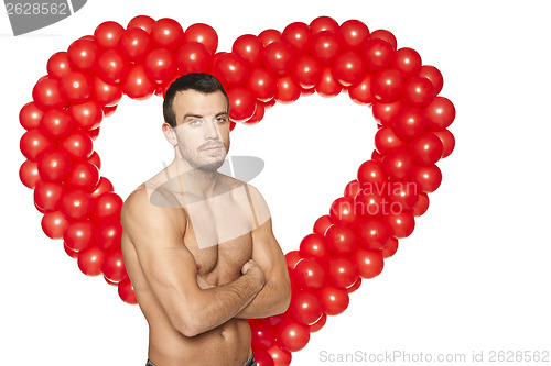 Image of Shirtless man standing at heart shape background
