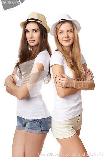 Image of Two women standing leaning on each other
